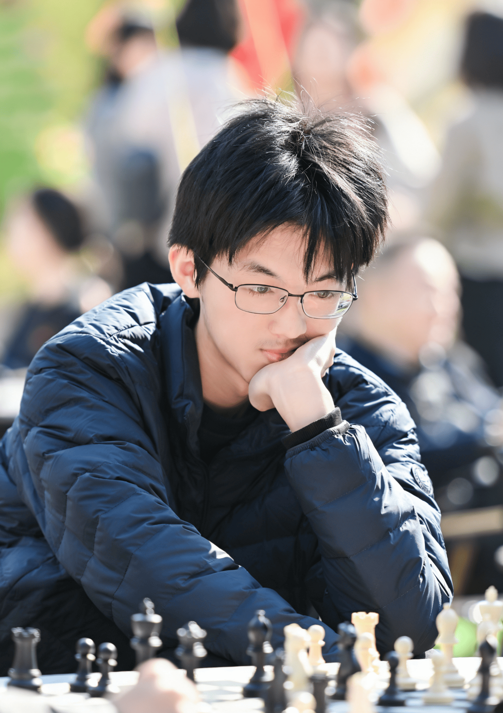 A portrait of Jefferson Li playing chess.